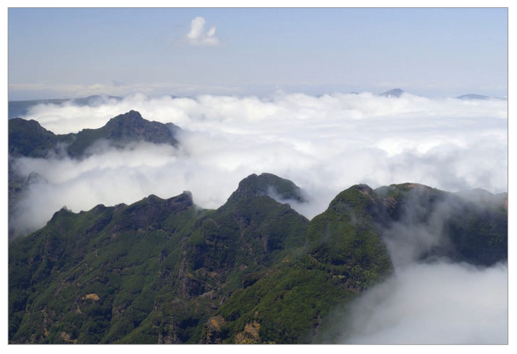 Cloud covering the hills with clear air above and in the valleys.